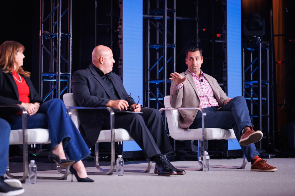 Bill West, Executive Director of SWI, with panelists on stage - SWI